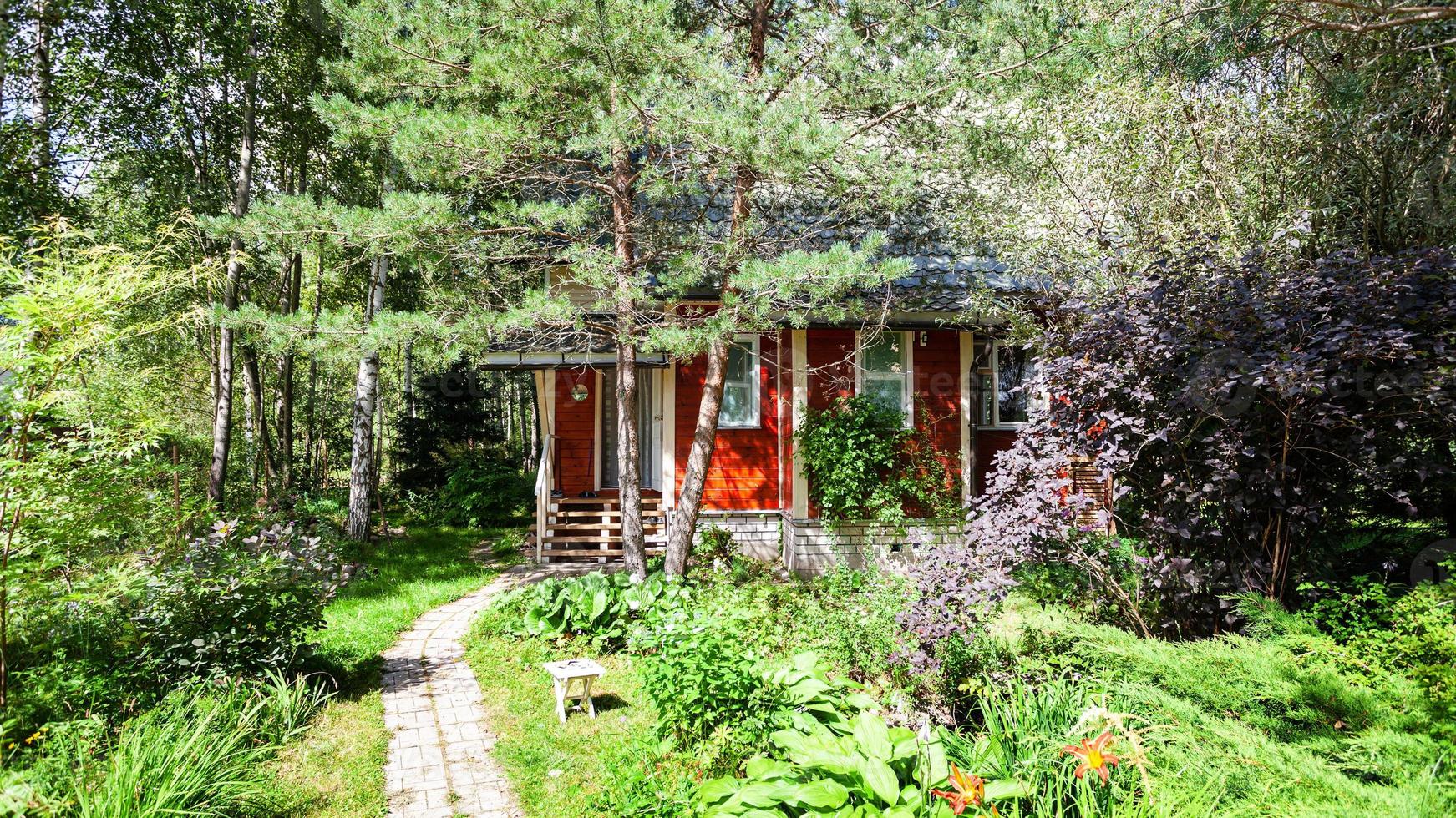 green ornamental garden with wooden country house photo
