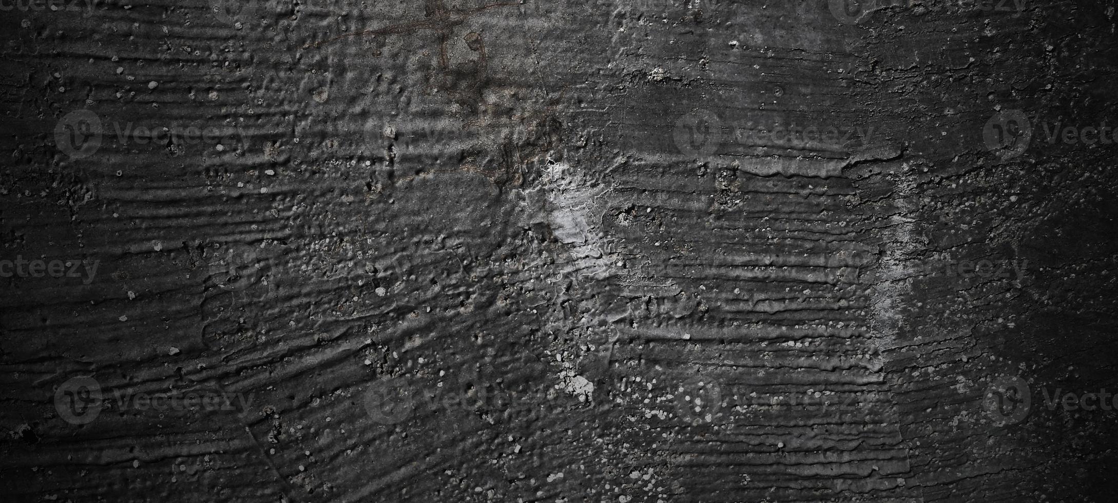 fondo de piedra negra oscura. textura de hormigón negro aterrador. fondo de pared de piedra. foto