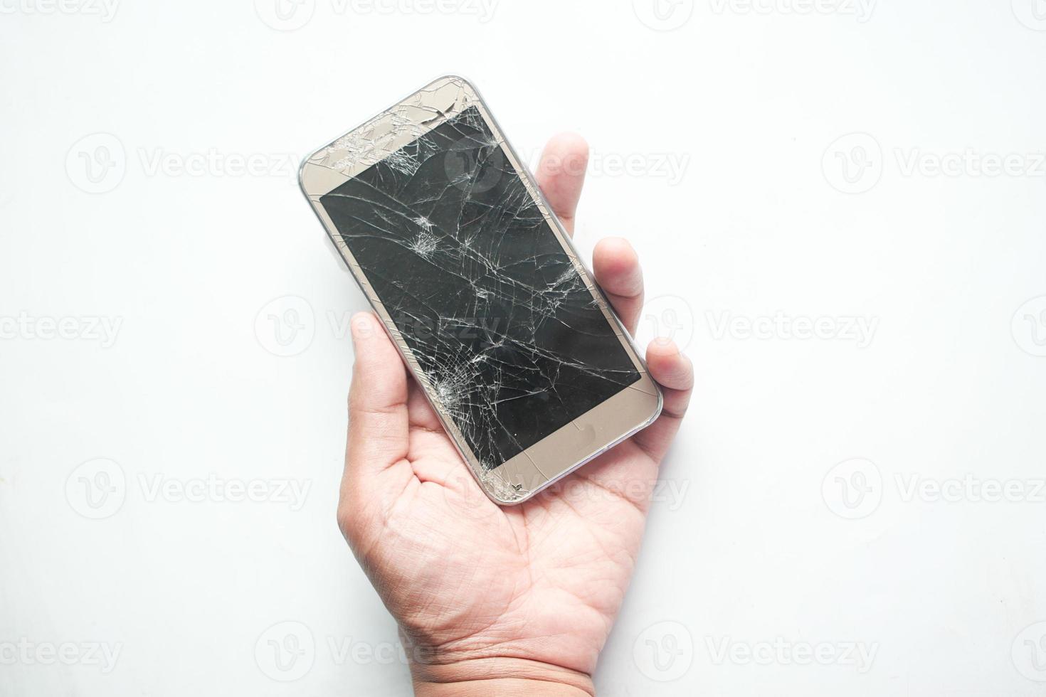 man hand holding broken smart phone on white background photo