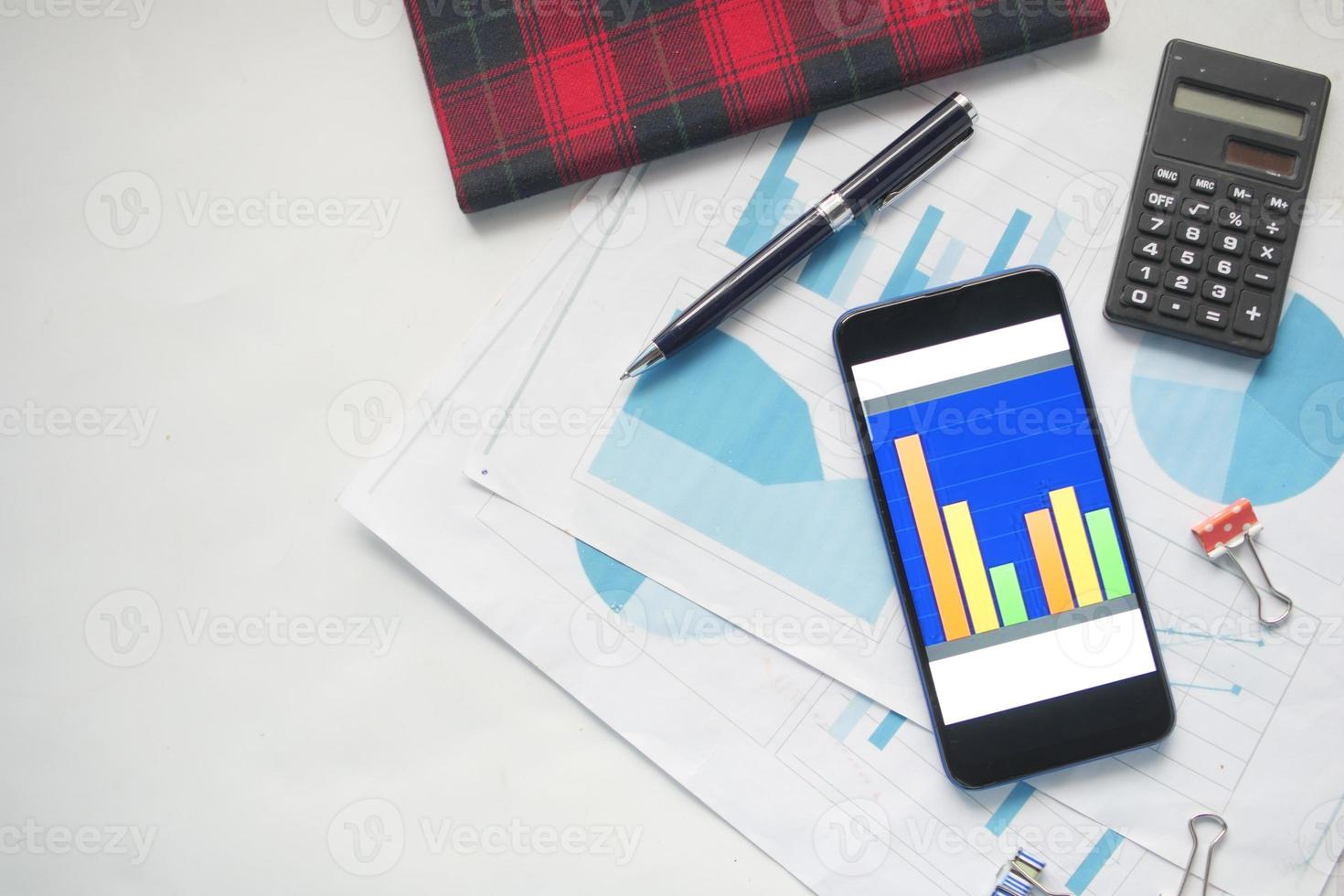 top view of financial chart display on smart phone on table photo