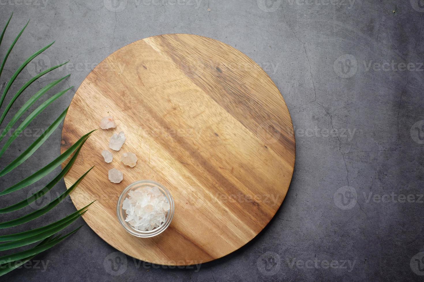 top view of pink rock salt on a chopping board on table photo