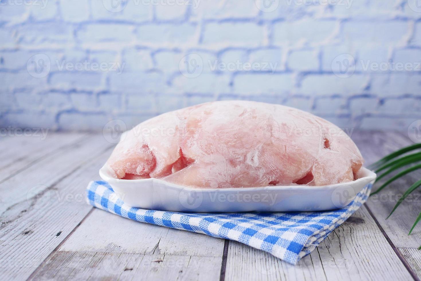 raw chicken breast in a packet on table photo