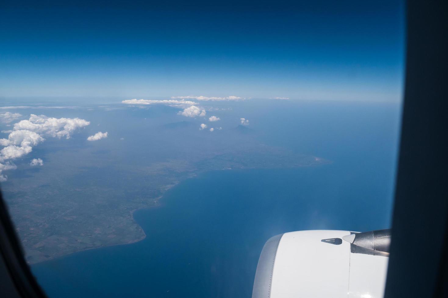 Bali island in tropical sea, veiw from airplane sight photo