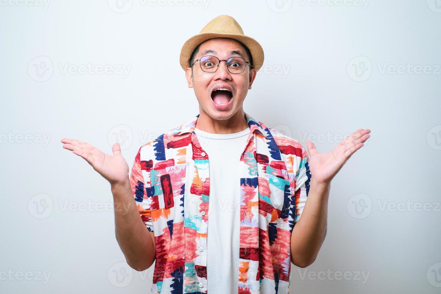 Asian man celebrating crazy and amazed for success with arms raised and open eyes screaming excited photo