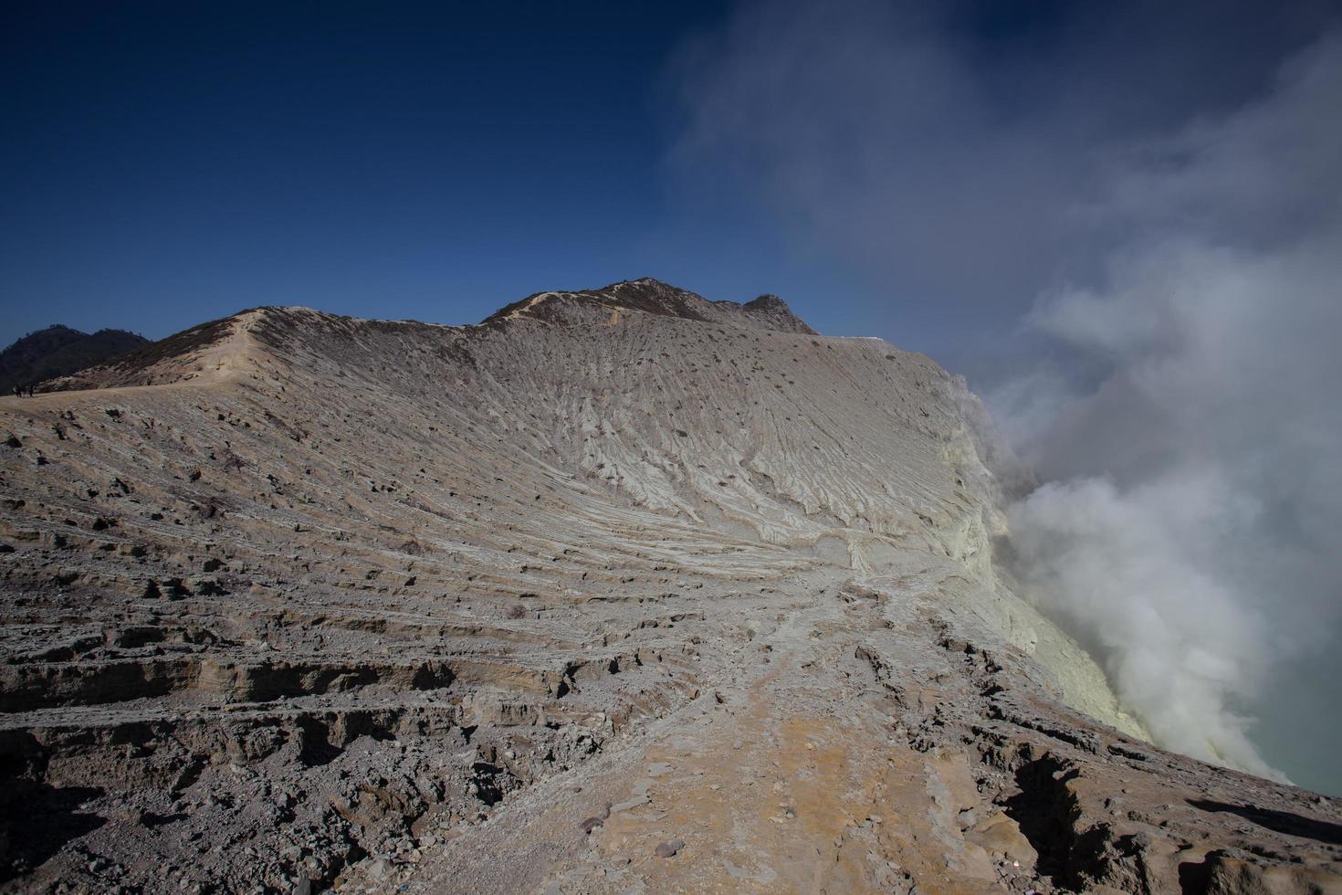 Sulfur mine with workers in Kawah Ijen, Java, Indonesia photo