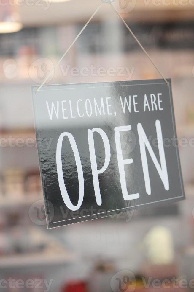 Open sign hanging front of cafe . photo