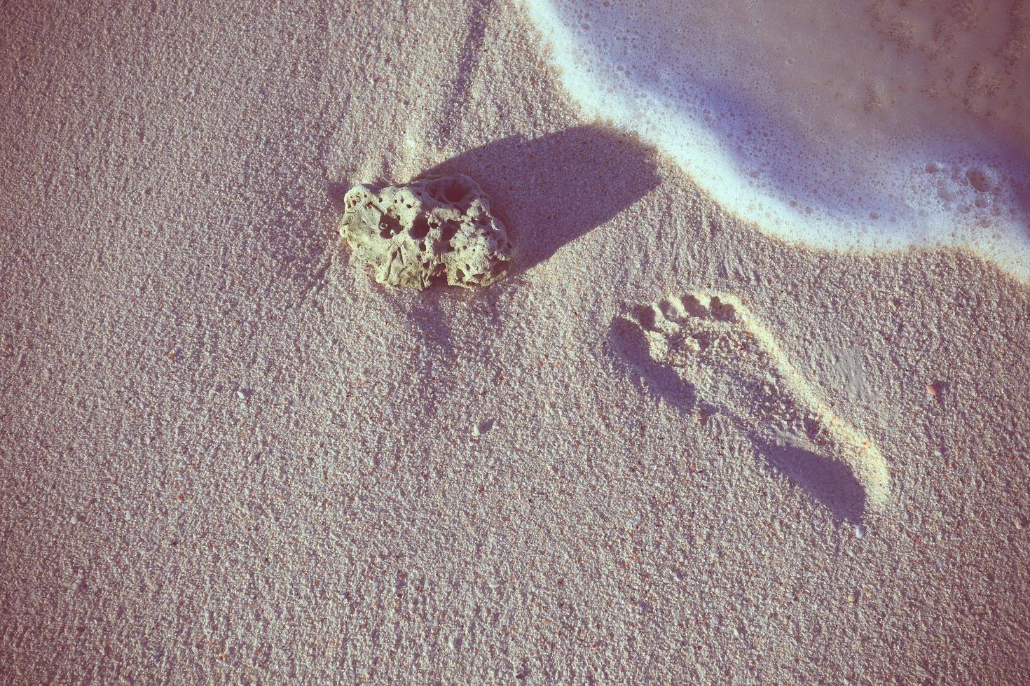 Lonely trace from a bare foot on sand. photo