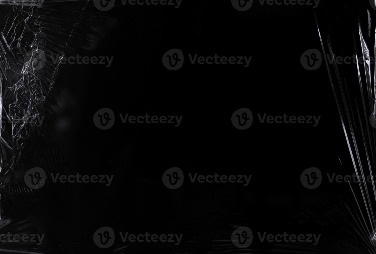 Black transparent plastic wrap texture overlay background. Realistic plastic for poster design and photo overlay effect. Wrinkled plastic surface pattern for graphic design sources and element.