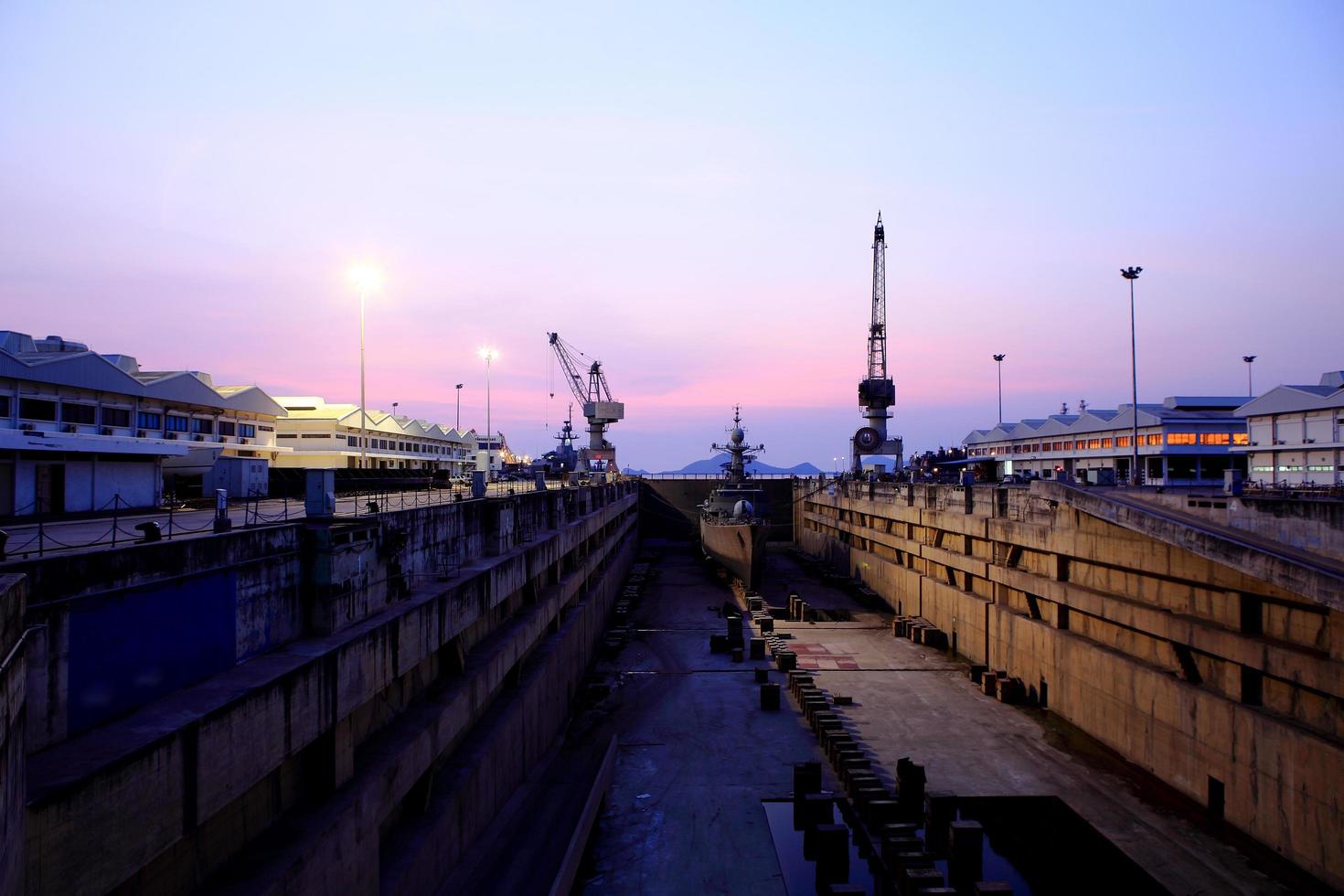 Crane near a covered dry dock at the shipyard photo