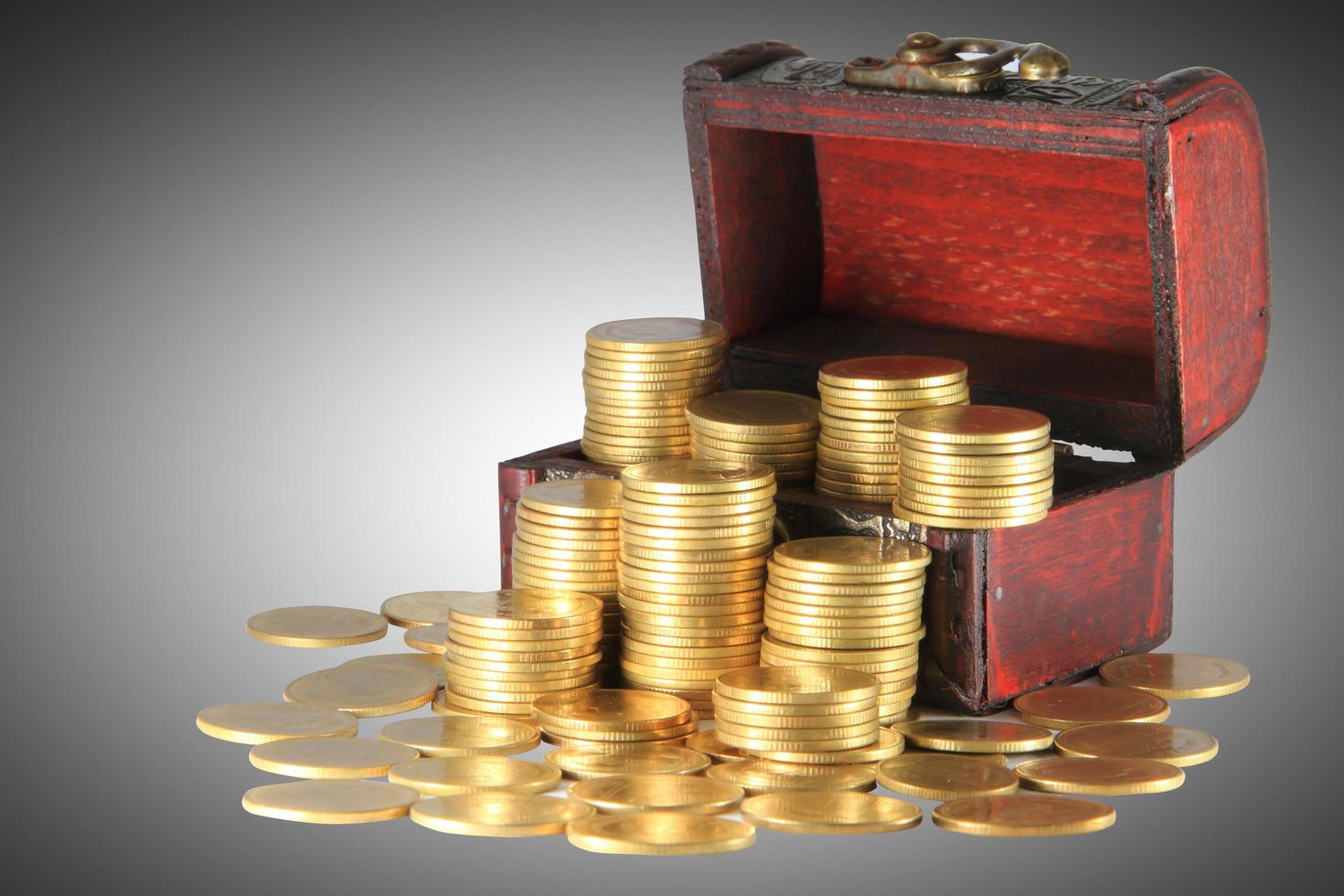 A wooden ancient chest full of money photo