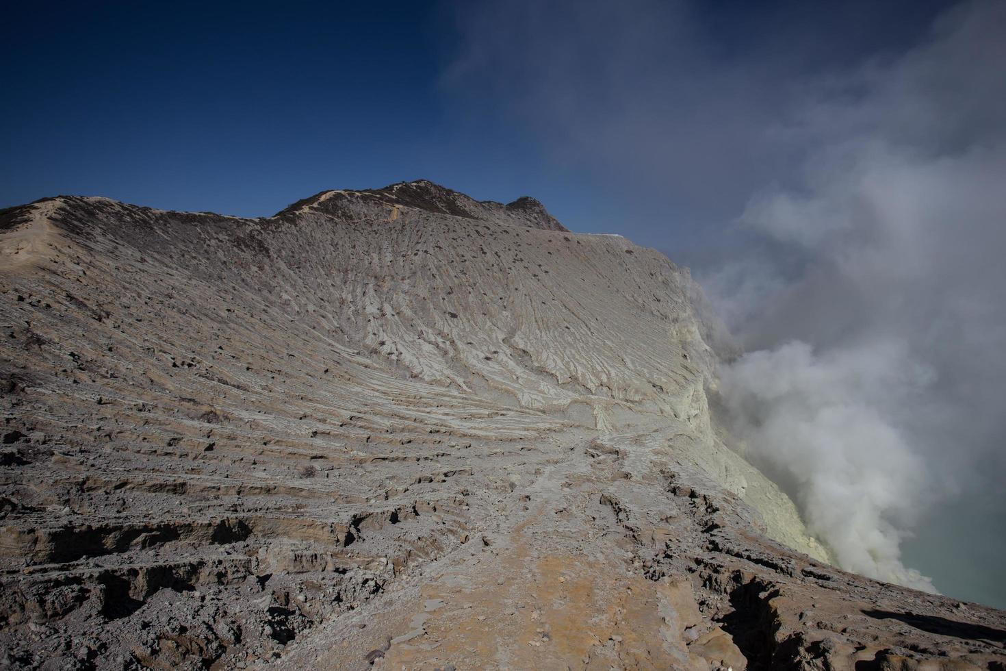 Sulfur mine with workers in Kawah Ijen, Java, Indonesia photo