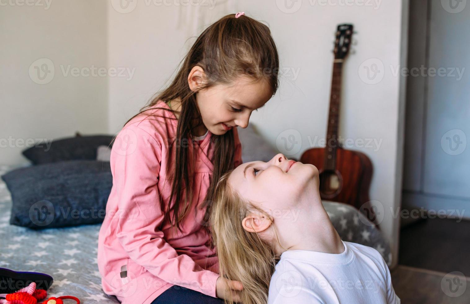 Two girls friends play at home after school, have fun photo