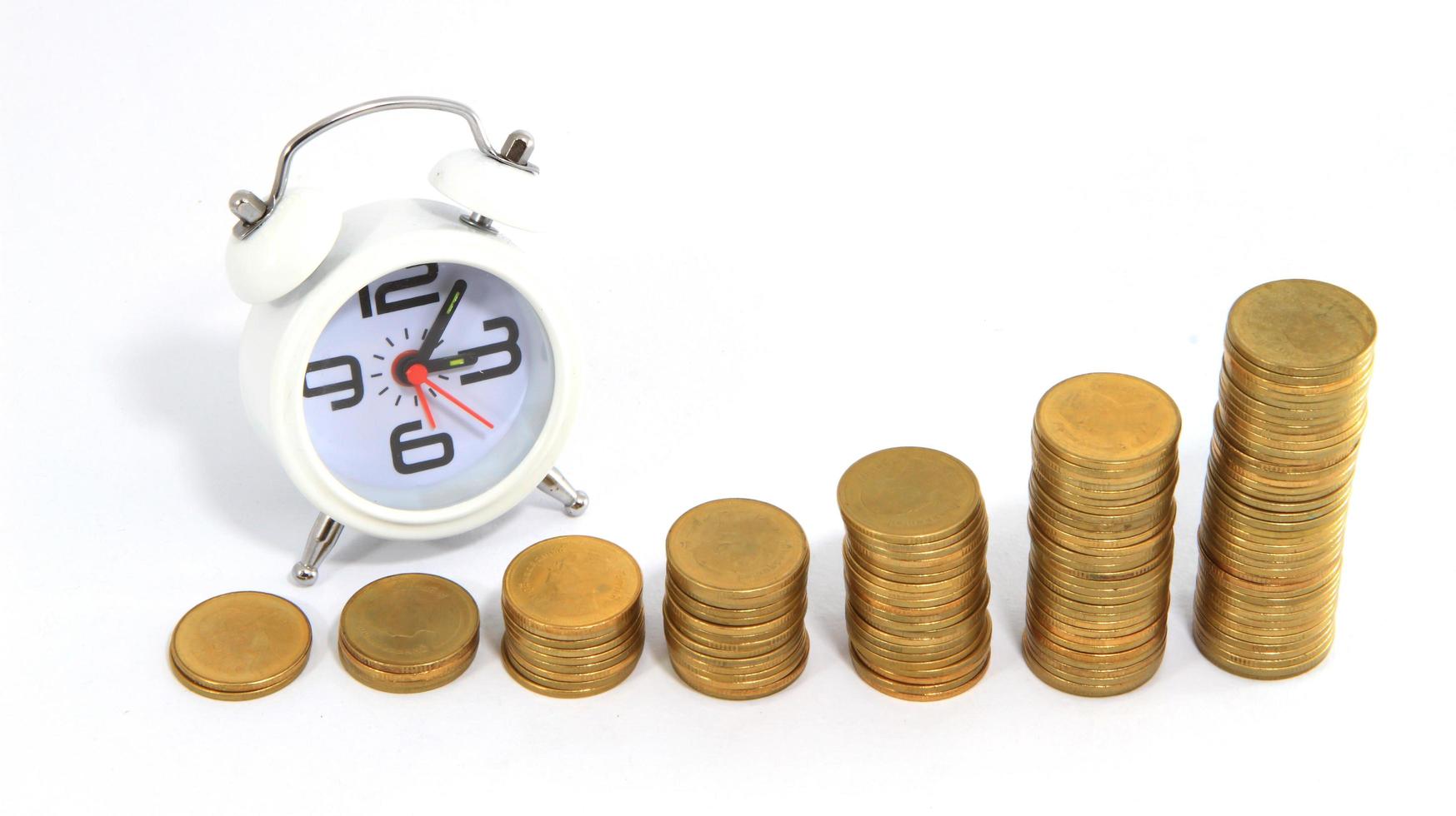 Alarm clock and money isolated on white photo