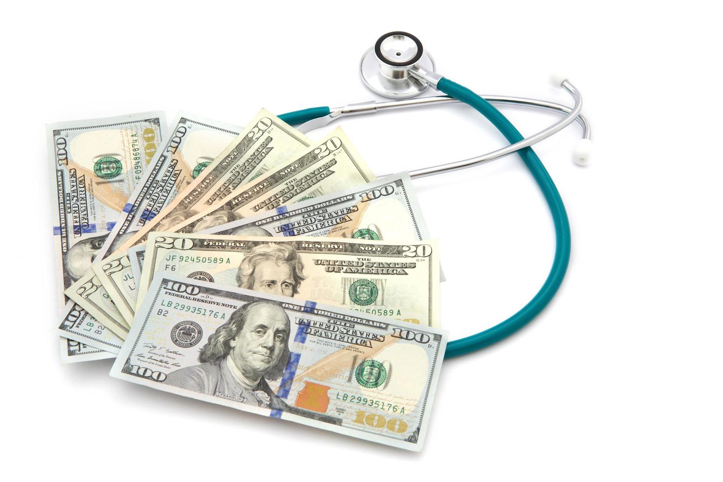 health care costs - Stethoscope on money background photo