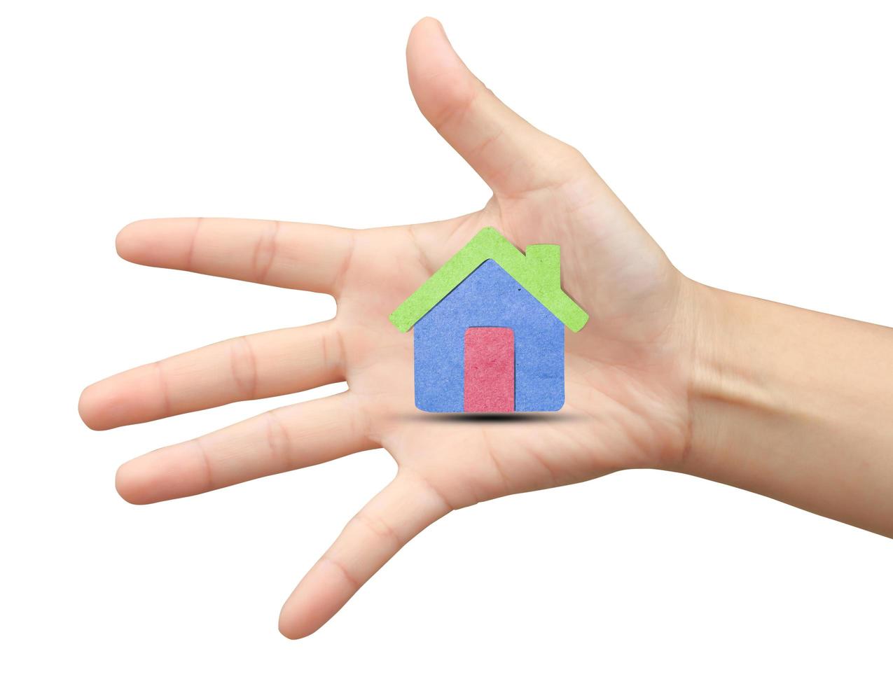 human hand   a house   with recycled paper stick photo