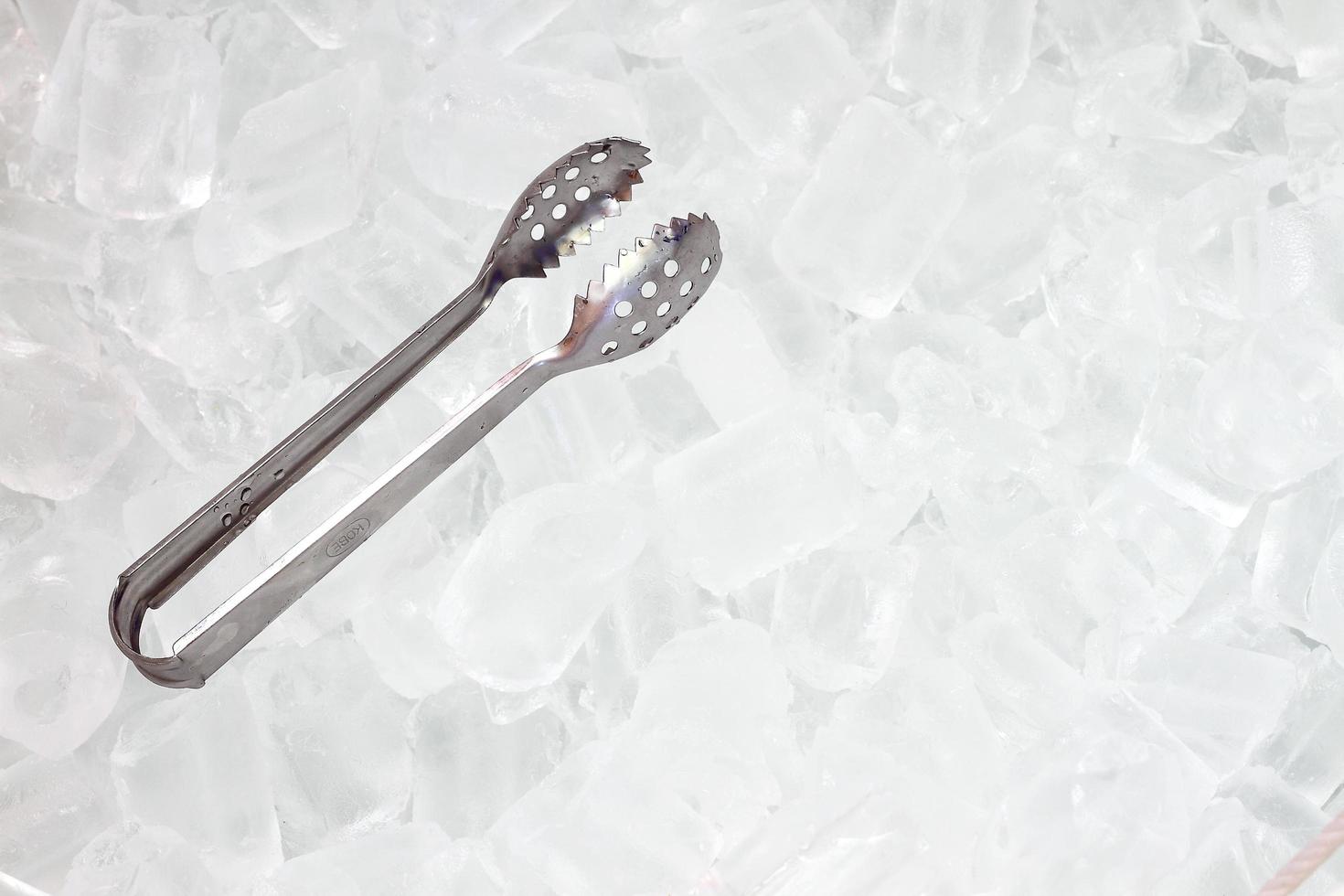 ice   with tongs closeup photo