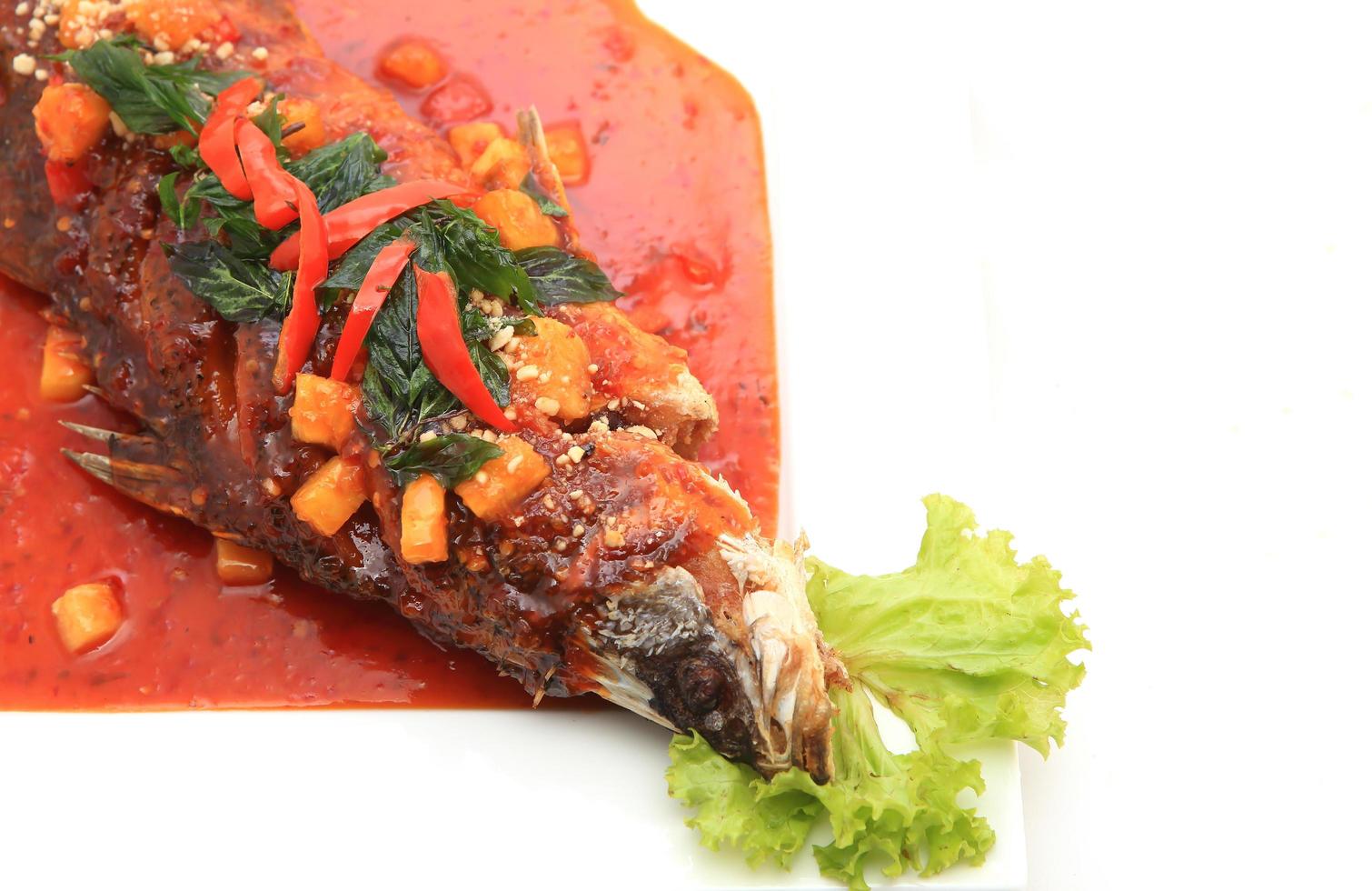 Fried snapper with chili sauce on the plate photo