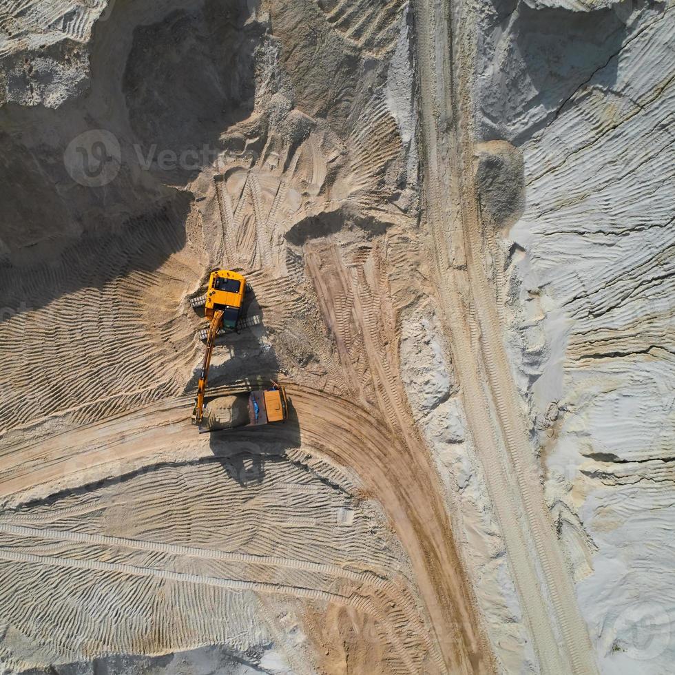 Aerial view of sand quarry with bulldozer photo