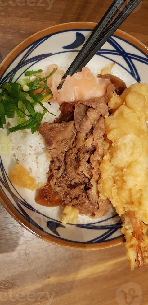 Japanese traditional food beef teriyaki with stickt rice and tempura shrimp sliced spring onion in a bowl photo