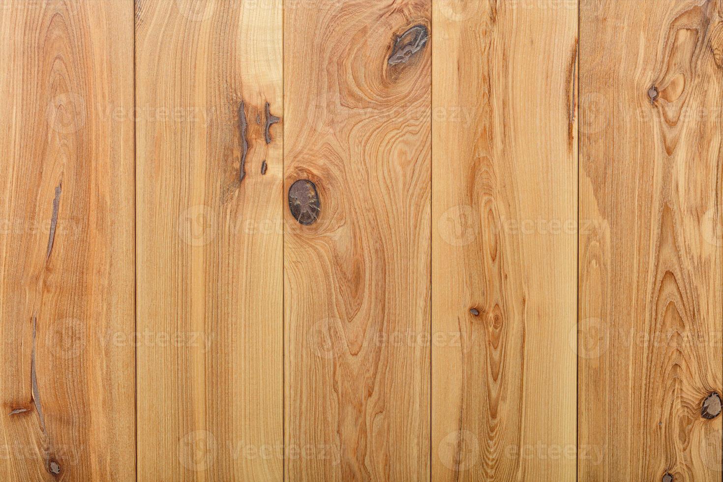 Vertical wooden planks with a pronounced texture of fibers and knots. photo