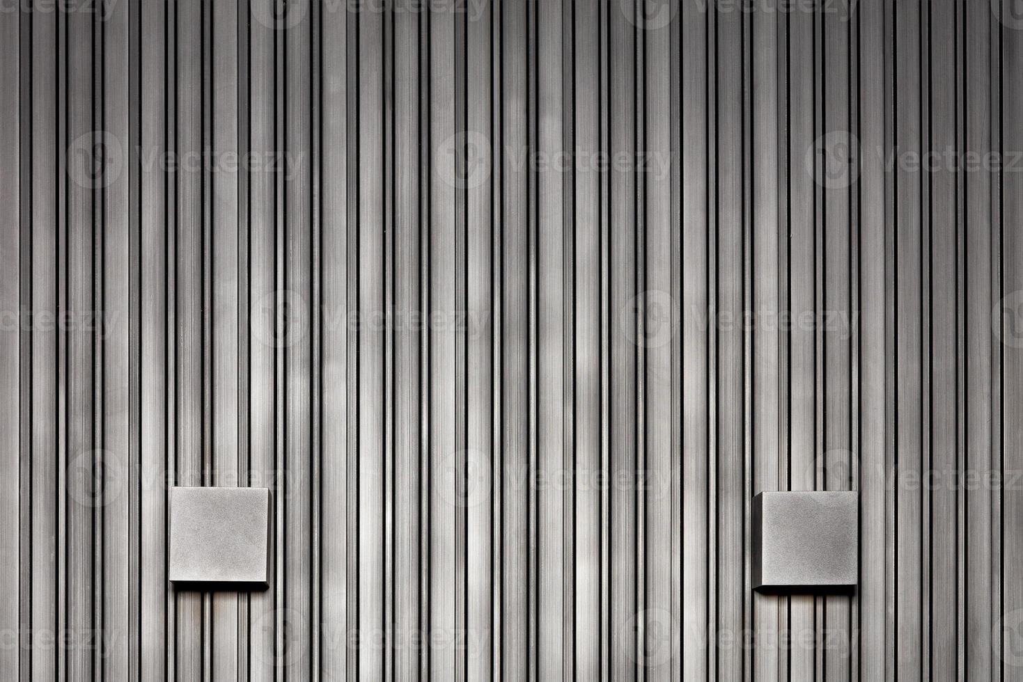 Stylish wall lights and wood wall with black silver vertical rails. photo