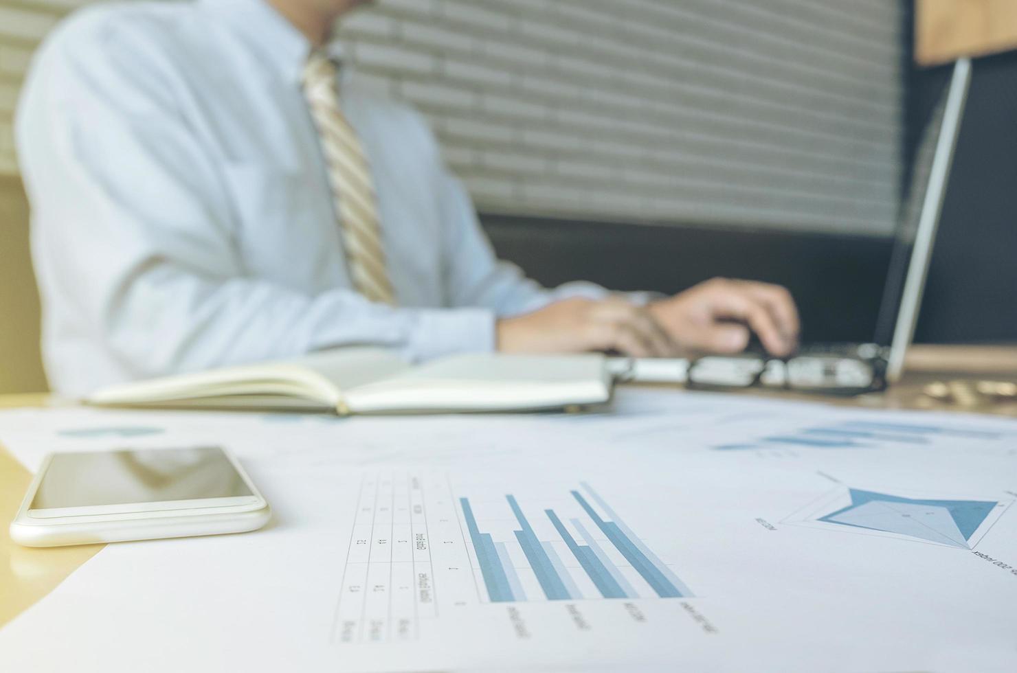 business man working document and laptop in office morning light. business concept. photo