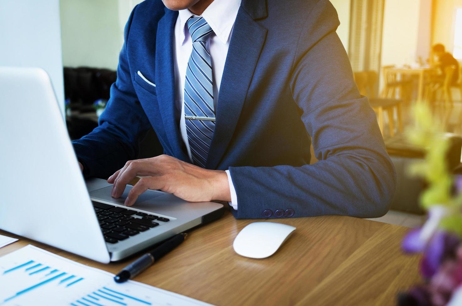 businessman hand working with new modern computer and business strategy as concept. photo