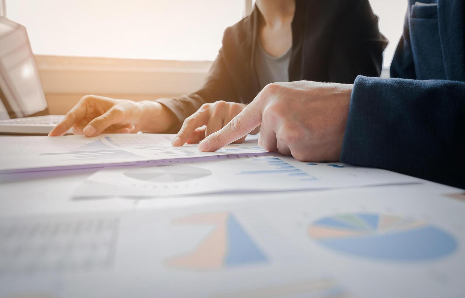 Business adviser analyzing financial figures denoting the progress in the work of the company, business team concept. photo