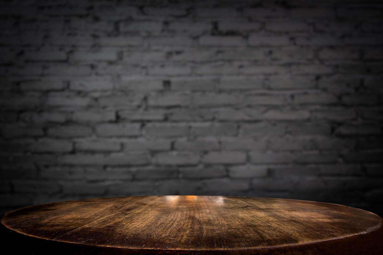Selected focus empty brown wooden table and wall texture or old black brick wall blur background image. for your photomontage or product display photo
