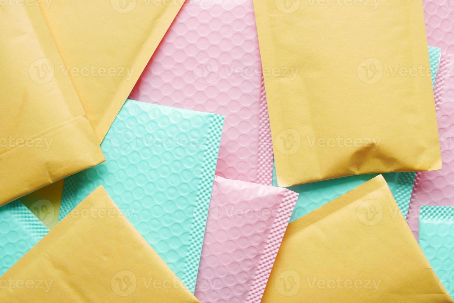 green and pink color paper bubble envelope on table photo