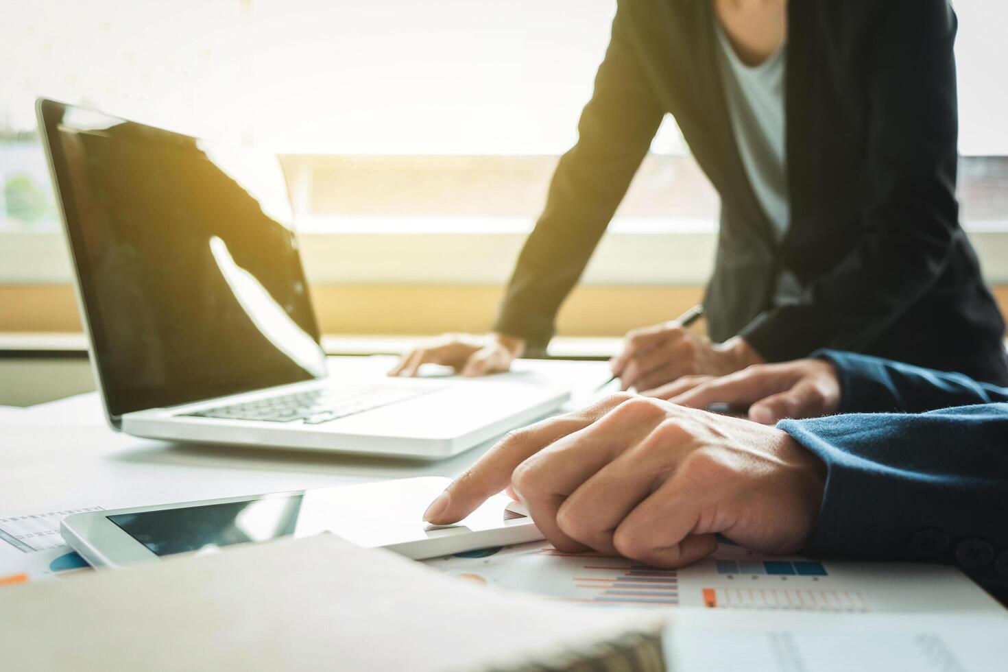 Business adviser analyzing financial figures denoting the progress in the work of the company, business team concept. photo