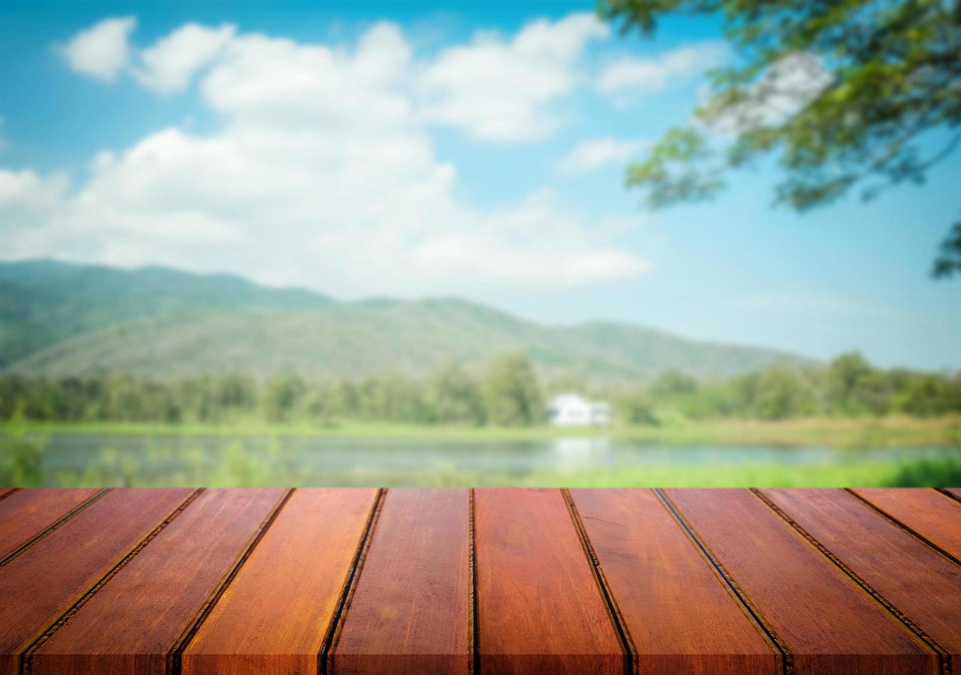 Selected focus empty brown wooden table and blue sky or mountain blur background with bokeh image. for your photomontage or product display. photo