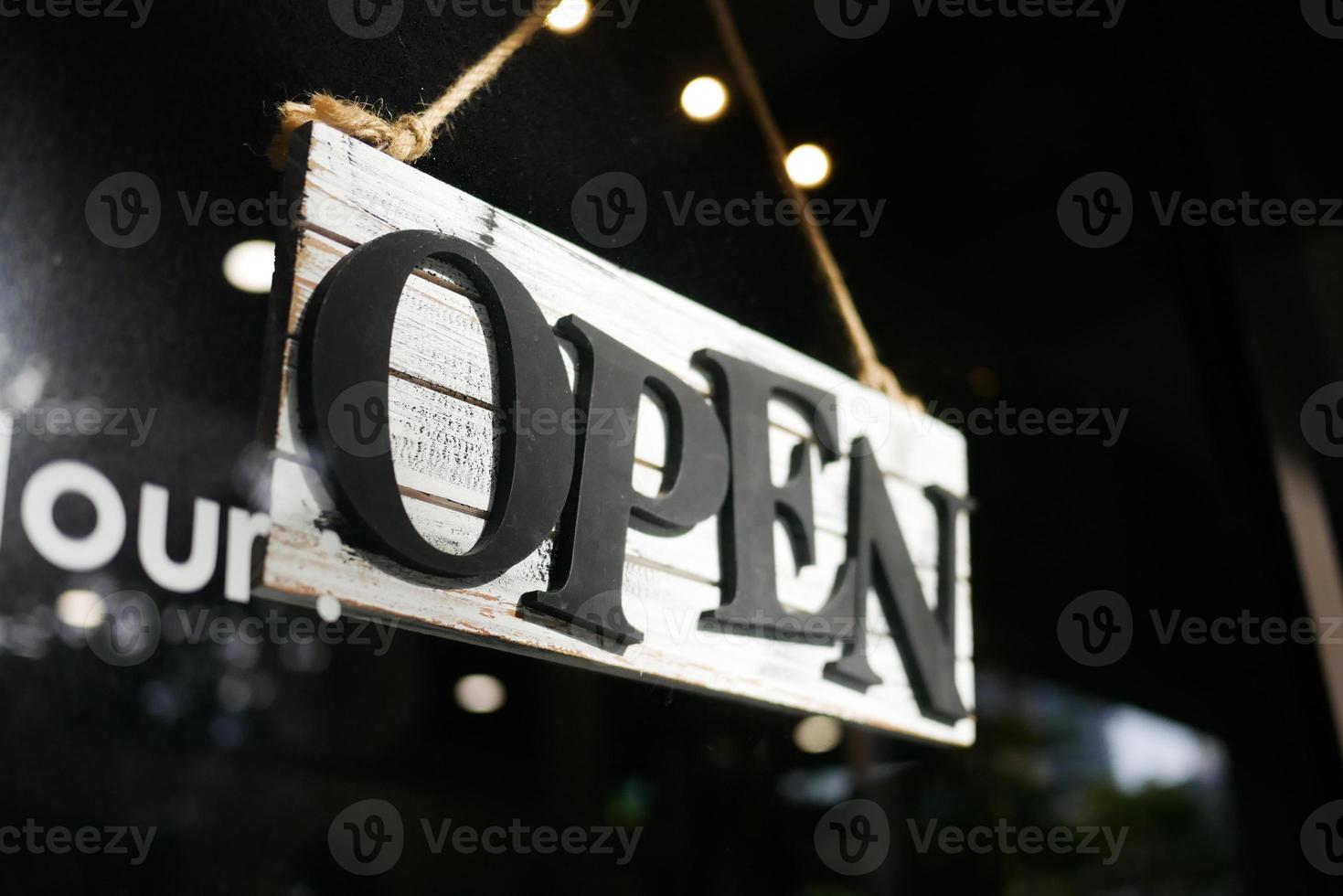 Open sign hanging front of cafe . photo