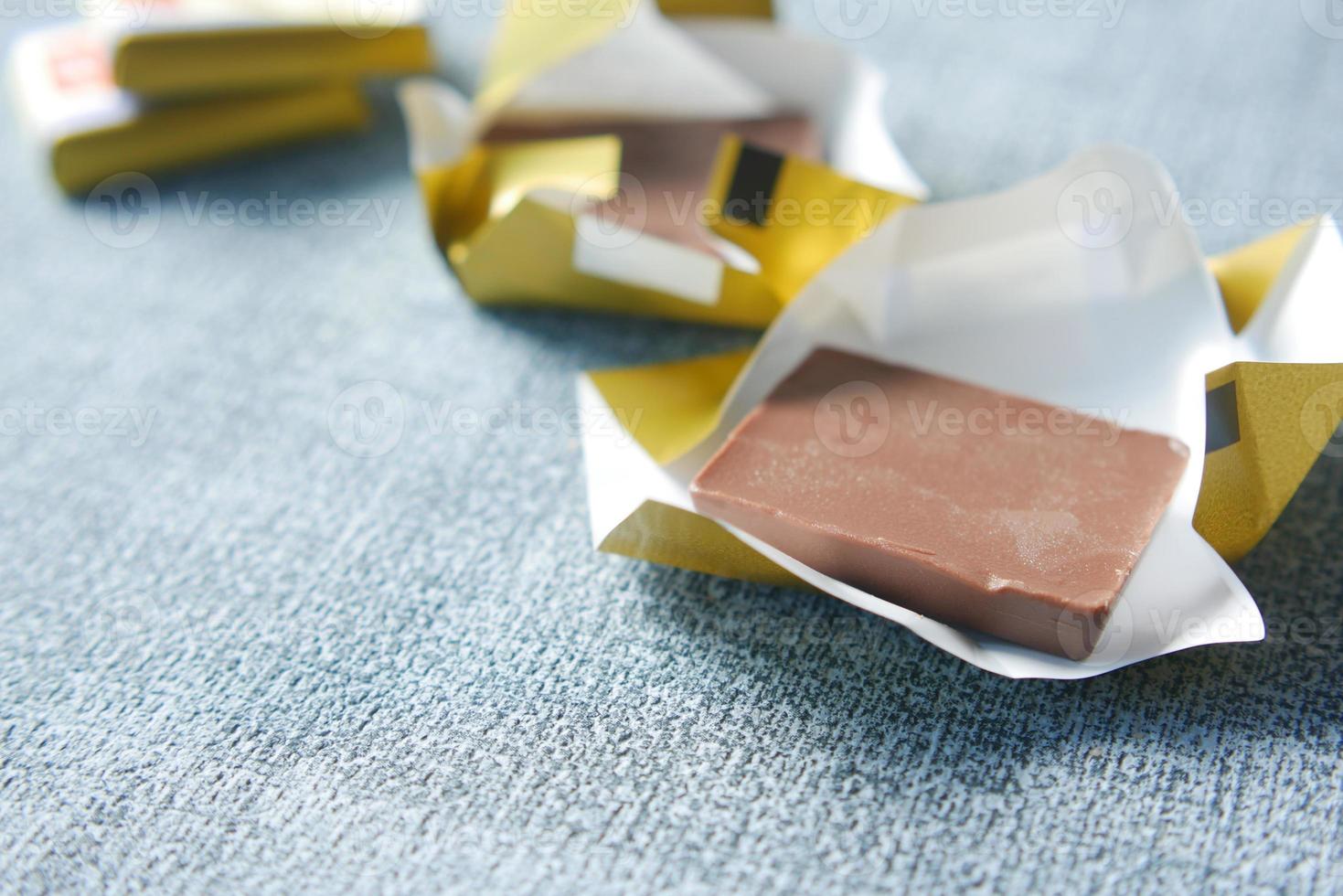 dark chocolate in a paper packet on table photo