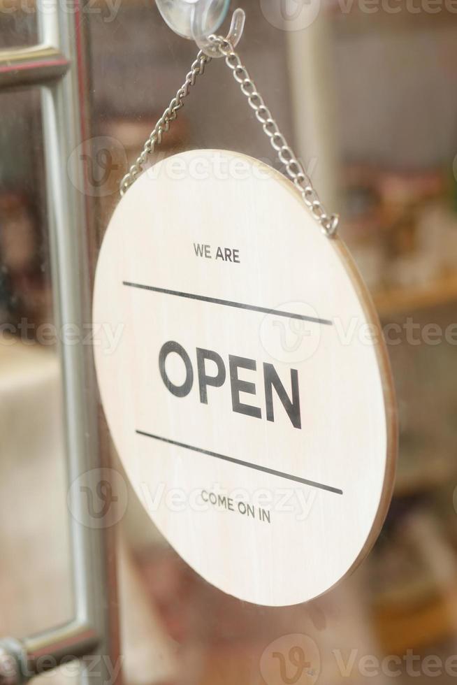 Open sign hanging front of cafe . photo