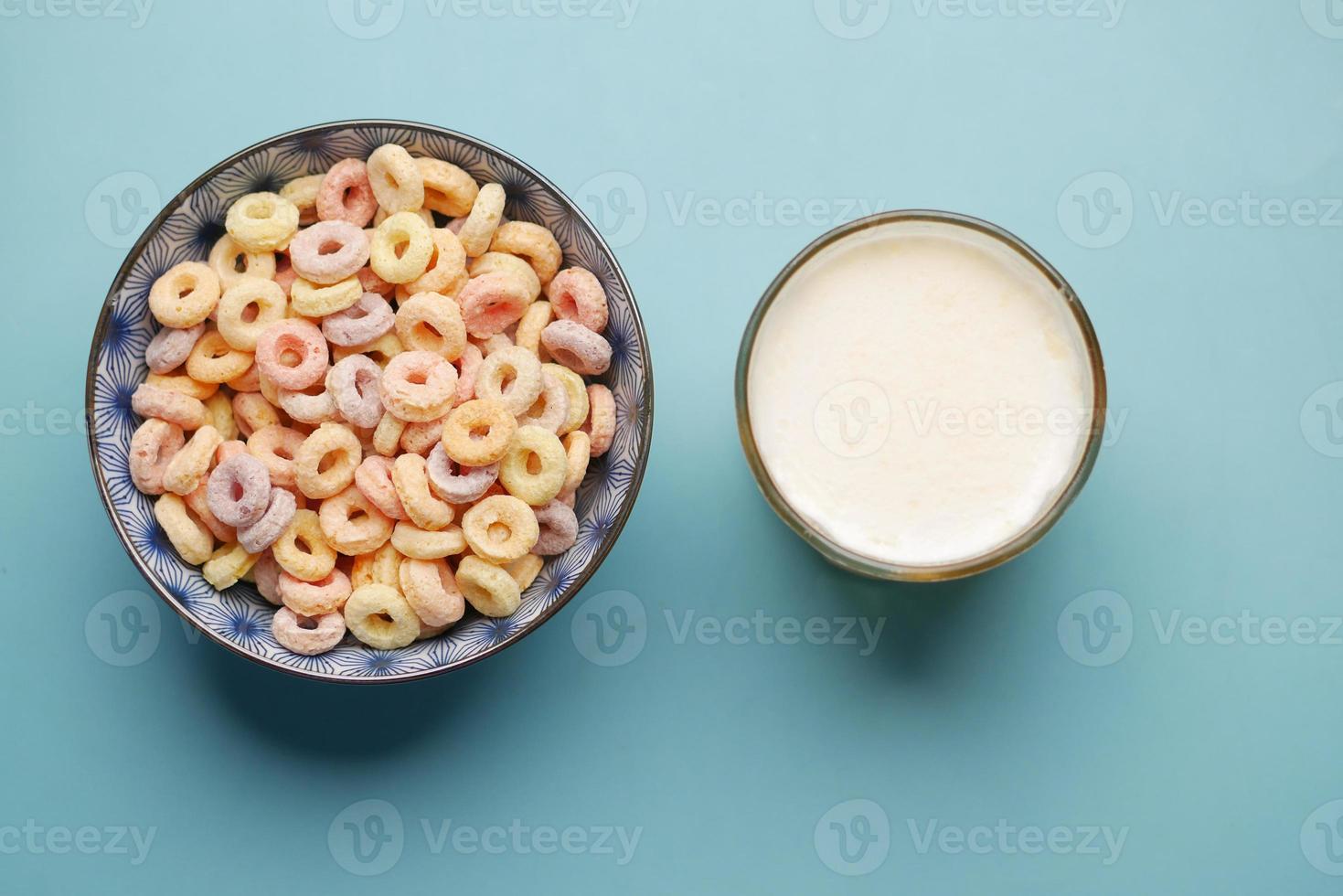 colorful cereal corn flakes in a bowl and milk on color background photo
