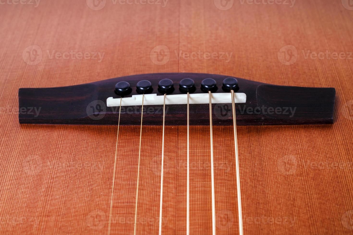 wood texture of lower deck of six strings acoustic guitar on white background. guitar shape photo