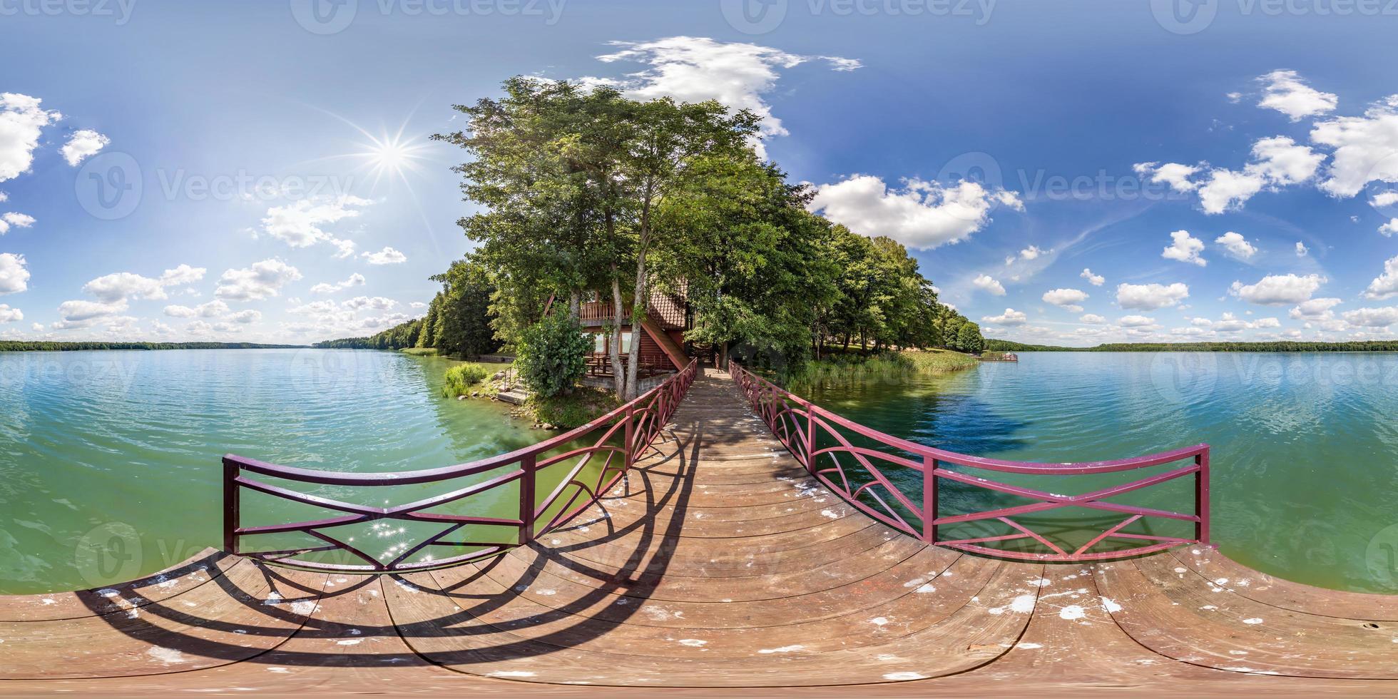 full seamless spherical hdri panorama 360 degrees  angle view on wooden pier of huge lake or river in sunny summer day and windy weather with beautiful clouds in equirectangular projection, VR content photo