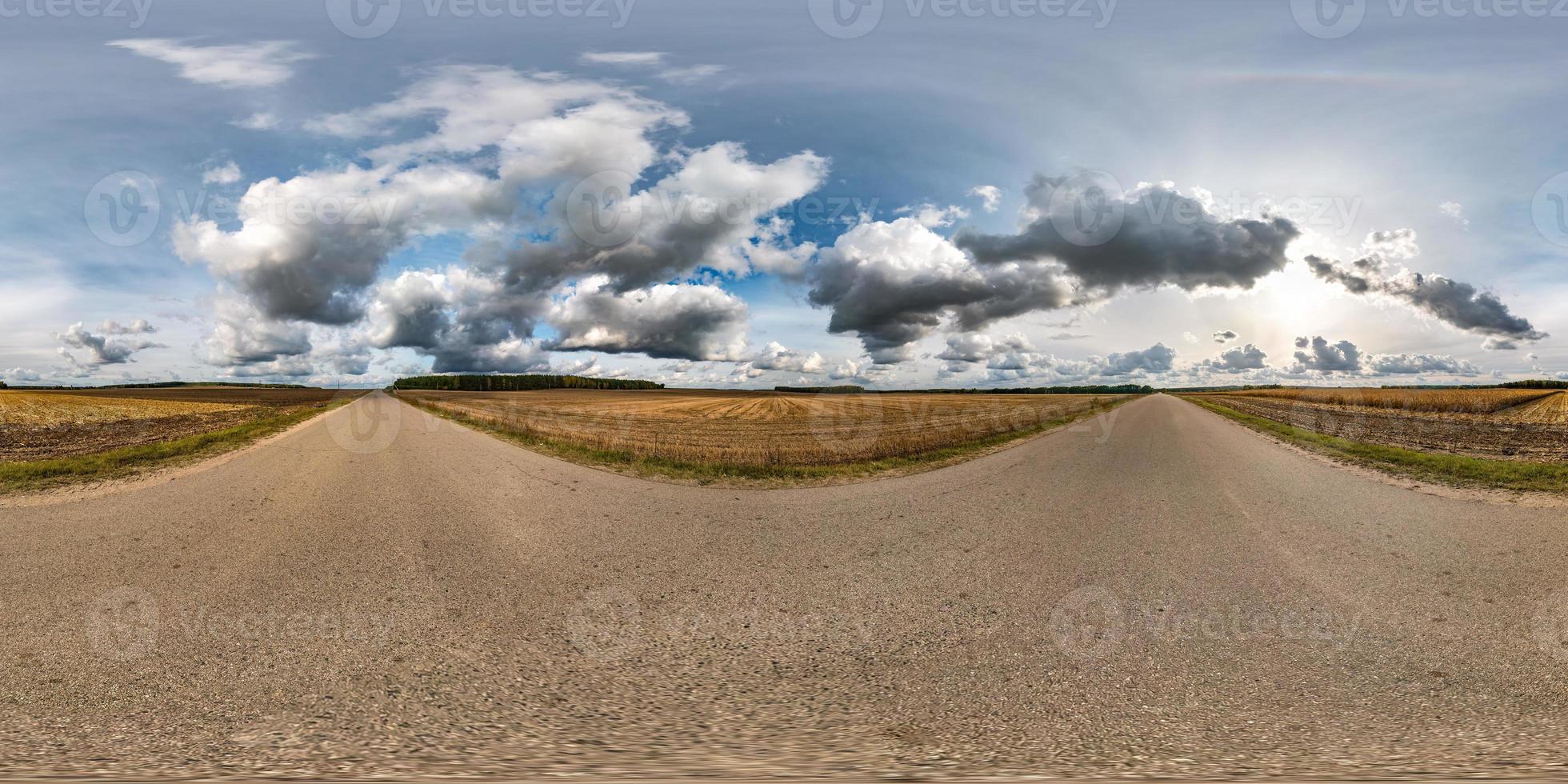 full seamless spherical hdri panorama 360 degrees angle view on asphalt road among fields in autumn day with awesome clouds in equirectangular projection, ready for VR AR virtual reality content photo