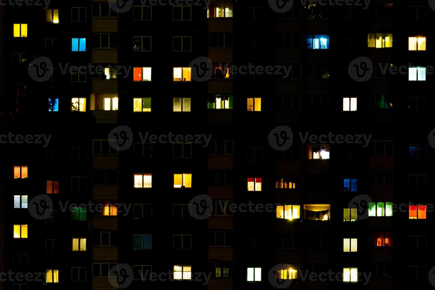 Flat night panorama of multicolor light in windows of multistory buildings. life in big city photo
