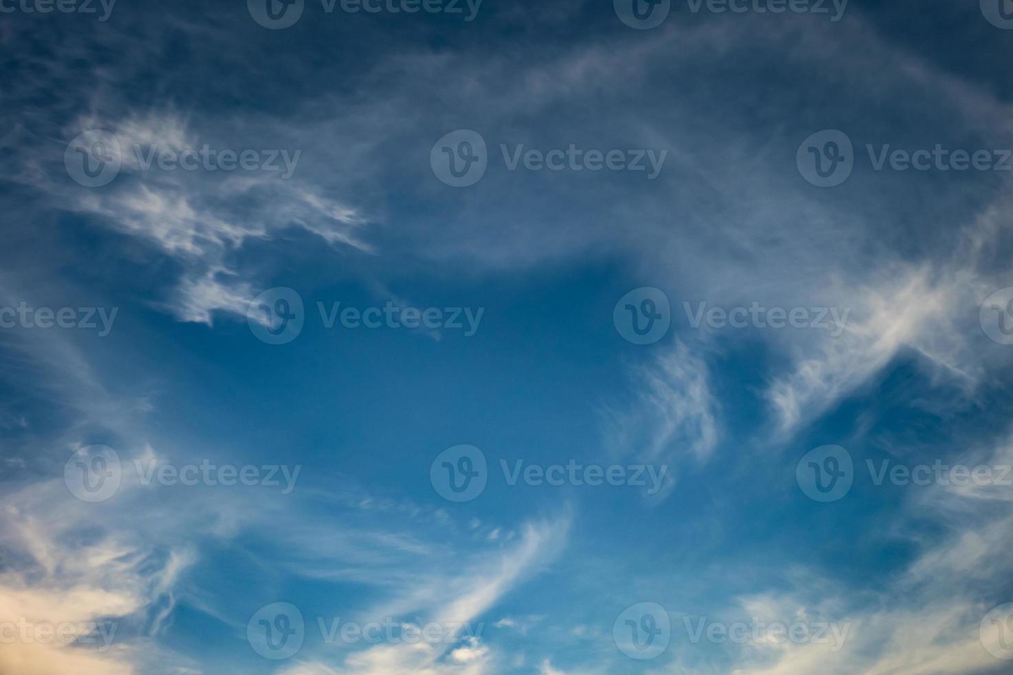 Blue sky background with tiny stratus cirrus striped clouds. Clearing day and Good windy weather photo