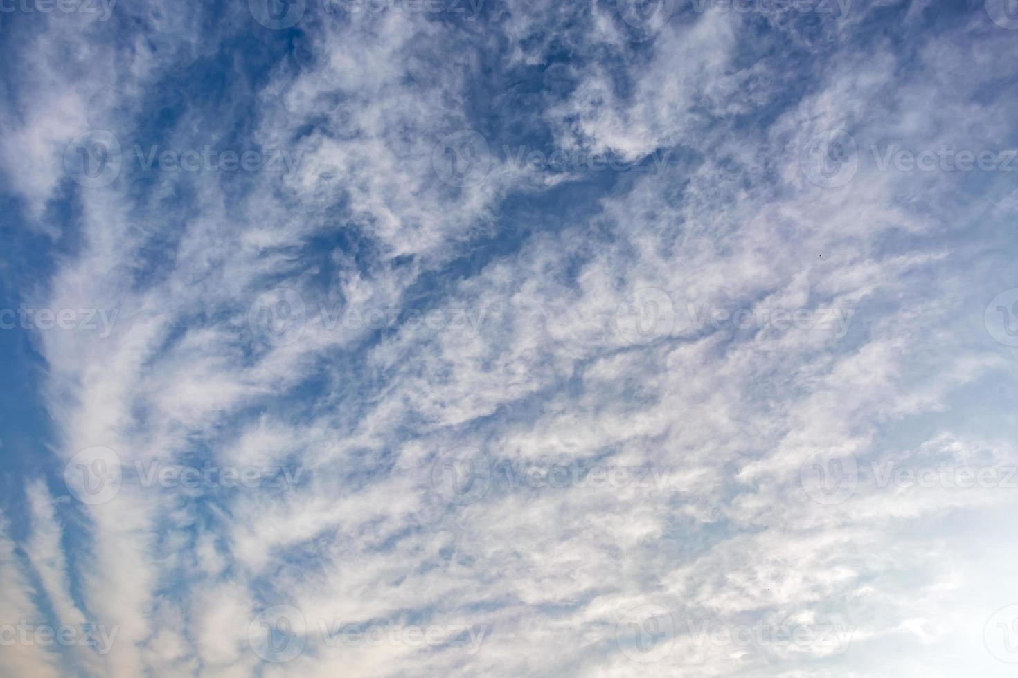 Blue sky background with tiny stratus cirrus striped clouds. Clearing day and Good windy weather photo