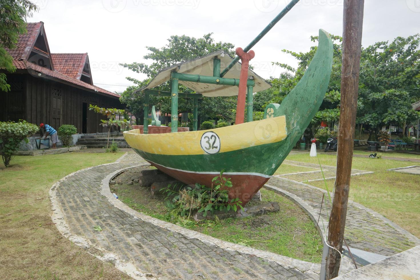 a statue of a replica of a yellow green boat photo