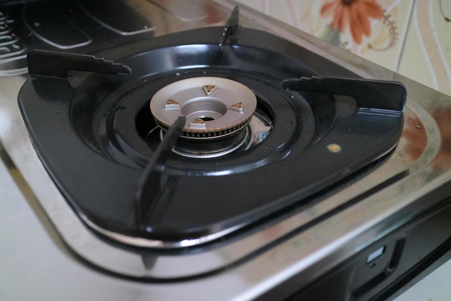 black square placemats on the gas stove photo