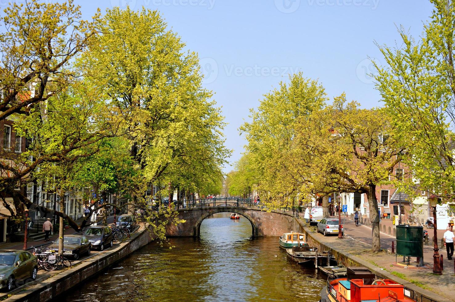 Beautiful river with boats and bridge in Amsterdam, Holland Netherlands photo