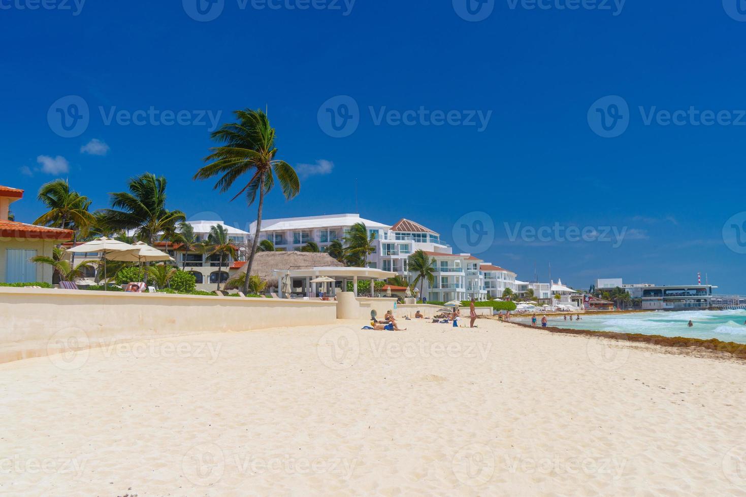 Sandy beach on a sunny day with hotels in Playa del Carmen, Mexico photo