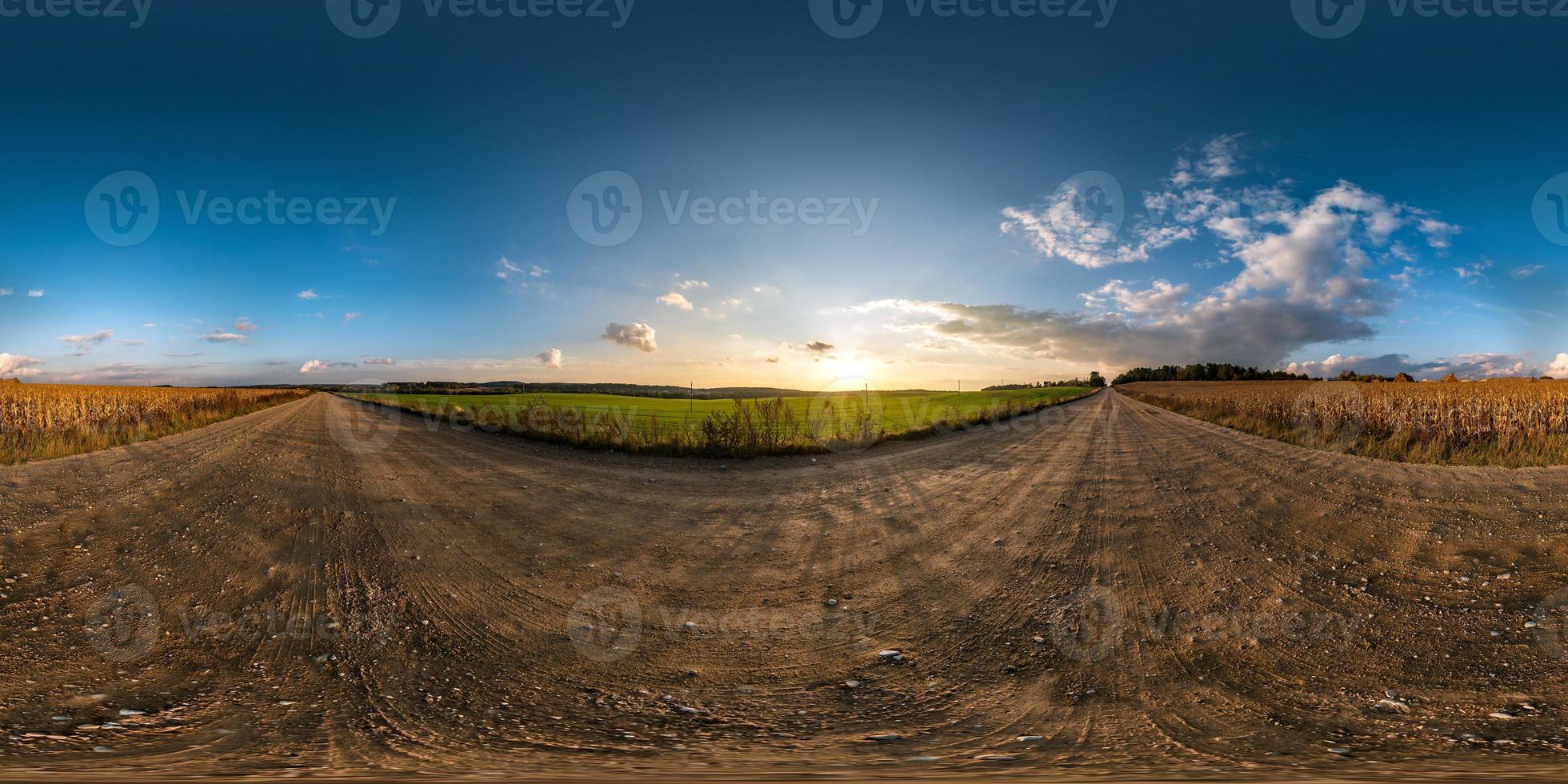 full seamless spherical hdri panorama 360 degrees angle view on gravel road among fields in summer evening sunset with awesome clouds in equirectangular projection, ready for VR AR virtual reality photo