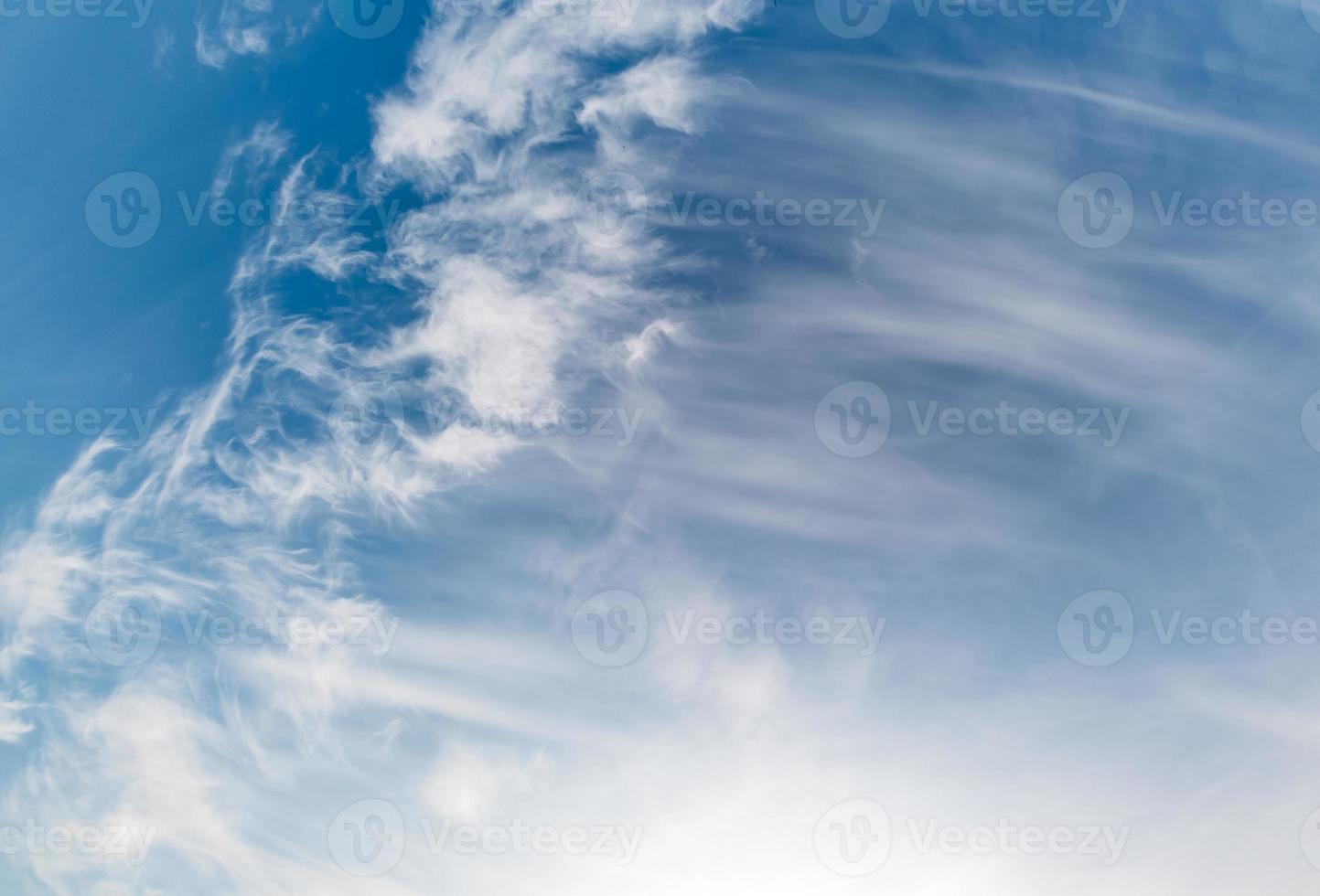 Blue sky background with tiny stratus cirrus striped clouds. Clearing day and Good windy weather photo