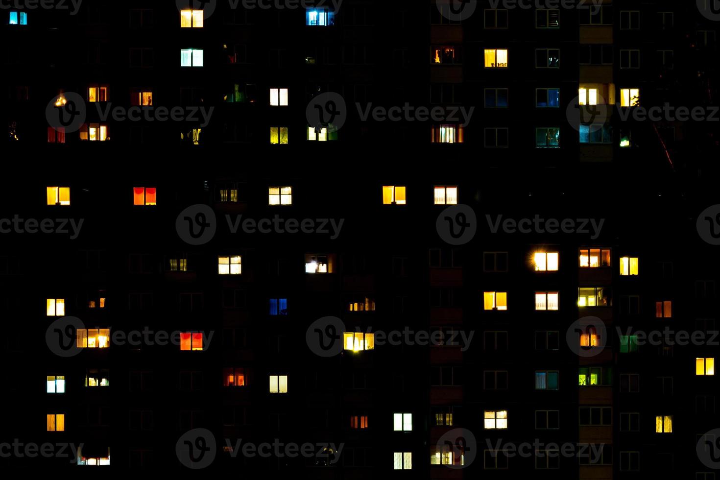 Flat night panorama of multicolor light in windows of multistory buildings. life in big city photo