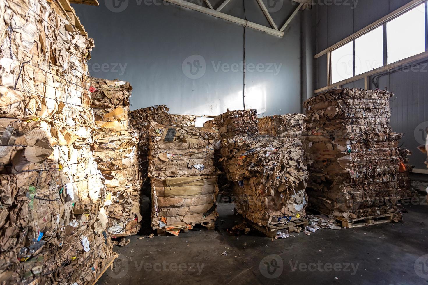 Paper pressed bales at the modern waste hazardous processing plant. Separate garbage collection. Recycling and storage of waste for further disposal. Business for sorting and processing of waste. photo